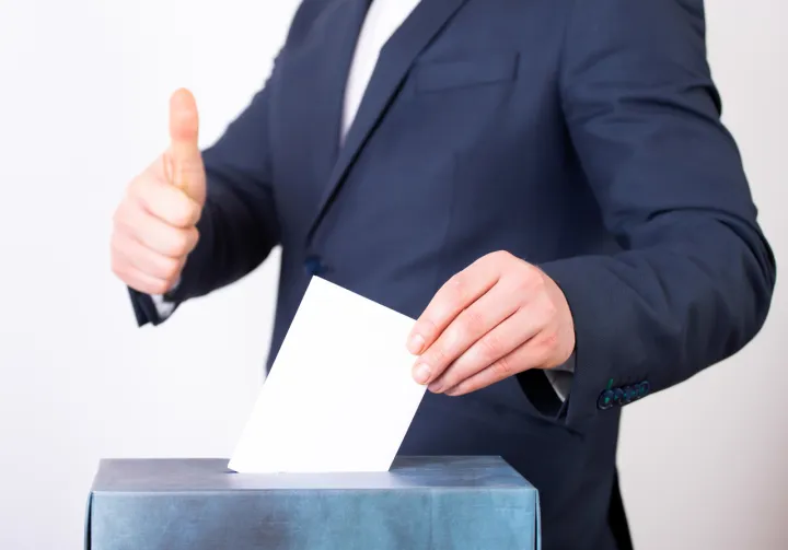 Person placing vote in Ballot Box